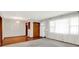Bright living room with hardwood floors, plush carpet, large windows and a white entry door at 3322 N Riley N Ave, Indianapolis, IN 46218