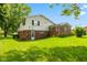 The beautiful backyard features lush green grass and colorful flower beds at 3388 S Leonard Rd, New Palestine, IN 46163