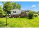 A spacious backyard with a lush green lawn and mature trees at 3388 S Leonard Rd, New Palestine, IN 46163