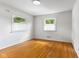 Bedroom featuring wood floor and two bright windows at 3388 S Leonard Rd, New Palestine, IN 46163