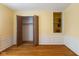 Comfortable yellow bedroom with a built-in bookshelf and a closet with wooden doors at 3388 S Leonard Rd, New Palestine, IN 46163