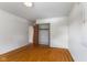 Bright bedroom with hardwood floors, closet, and neutral walls and a view of a window at 3388 S Leonard Rd, New Palestine, IN 46163
