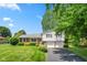 Charming split-level home featuring a brick facade and a spacious driveway at 3388 S Leonard Rd, New Palestine, IN 46163
