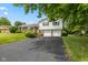 Charming split-level home featuring a brick facade and a spacious driveway at 3388 S Leonard Rd, New Palestine, IN 46163