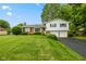 Charming split-level home featuring a brick facade, a two-car garage, and lush landscaping at 3388 S Leonard Rd, New Palestine, IN 46163