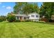 Charming split-level home featuring a brick facade, a two-car garage, and lush landscaping at 3388 S Leonard Rd, New Palestine, IN 46163