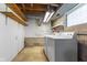 Functional laundry room with washer, dryer, and open shelving for storage at 3388 S Leonard Rd, New Palestine, IN 46163