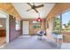 Inviting sunroom with wood paneling, lots of windows, and comfortable seating arrangements at 3388 S Leonard Rd, New Palestine, IN 46163