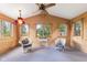 Bright and airy sunroom with wood paneled walls and large windows, perfect for relaxation at 3388 S Leonard Rd, New Palestine, IN 46163
