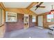 Cozy sunroom boasts wood accents, brick walls, and an abundance of natural light at 3388 S Leonard Rd, New Palestine, IN 46163