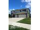 Modern two-story duplex featuring double garages, well-maintained lawns, and a concrete driveway under a sunny blue sky at 3609 Merchmont Rd, Bargersville, IN 46106