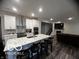Open concept kitchen features a large island with bar seating, modern appliances, and hardwood floors at 3609 Merchmont Rd, Bargersville, IN 46106