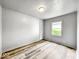 Cozy bedroom featuring fresh paint, new wood flooring, and natural light at 4034 N Temple Ave, Indianapolis, IN 46205