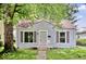 Charming single-story home with stone facade, mature trees, and a cozy front porch at 4034 N Temple Ave, Indianapolis, IN 46205