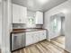 Bright kitchen features stainless steel appliances, white cabinets, and wood countertop at 4034 N Temple Ave, Indianapolis, IN 46205