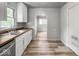 Open concept kitchen features stainless steel appliances, white cabinets, and wood countertop at 4034 N Temple Ave, Indianapolis, IN 46205