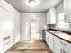 Bright kitchen features stainless steel appliances, white cabinets, and wood countertop at 4034 N Temple Ave, Indianapolis, IN 46205