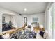 Staged living room with a blue rug, modern furniture, and ample natural light at 4034 N Temple Ave, Indianapolis, IN 46205