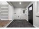 Basement space features a sliding barn door, a black exterior door, and carpeted floors at 4245 Norwaldo Ave, Indianapolis, IN 46205