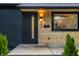 Close-up of the home's modern door, exterior lighting, and stylish light wood facade at 4245 Norwaldo Ave, Indianapolis, IN 46205