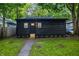 Charming black home with a well-manicured lawn and a paved walkway leading to the front door at 4245 Norwaldo Ave, Indianapolis, IN 46205