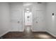 Hallway features two doors, hardwood floors, modern lighting, and white trim at 4245 Norwaldo Ave, Indianapolis, IN 46205