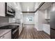Bright kitchen features stainless steel appliances, modern cabinetry, and a breakfast bar at 4245 Norwaldo Ave, Indianapolis, IN 46205