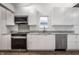 Modern kitchen with stainless steel appliances, light gray countertops, and bright white cabinetry at 4245 Norwaldo Ave, Indianapolis, IN 46205