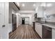 Open kitchen with stainless steel appliances, gray countertops, and access to other rooms at 4245 Norwaldo Ave, Indianapolis, IN 46205