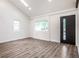 Living room with high ceilings, skylights, hardwood floors, and contemporary design elements at 4245 Norwaldo Ave, Indianapolis, IN 46205