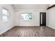 Bright living room with hardwood floors, large window, and stylish trim at 4245 Norwaldo Ave, Indianapolis, IN 46205
