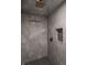 A marble tiled shower featuring bronze shower head and a built in soap dish at 4245 Norwaldo Ave, Indianapolis, IN 46205