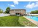 Backyard with in-ground pool, green lawn, and white vinyl fence, perfect for outdoor enjoyment at 5063 Haywood Ln, Plainfield, IN 46168