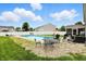 Sprawling backyard with swimming pool, dining table, and lounging area set on rock garden at 5063 Haywood Ln, Plainfield, IN 46168