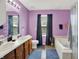 Bathroom featuring double sinks, an updated vanity, and a separate tub and shower at 5063 Haywood Ln, Plainfield, IN 46168