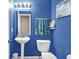 Blue powder room with modern sink and decor at 5063 Haywood Ln, Plainfield, IN 46168