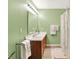 Well-lit bathroom with double vanity, framed mirror and shower with curtain at 5063 Haywood Ln, Plainfield, IN 46168