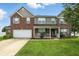 Charming two-story brick home with a welcoming front porch and manicured lawn at 5063 Haywood Ln, Plainfield, IN 46168