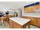 Charming kitchen with wooden cabinets, an island, and breakfast table at 5063 Haywood Ln, Plainfield, IN 46168