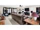 Comfortable living room with leather couch, fireplace, ceiling fan, and large TV at 5063 Haywood Ln, Plainfield, IN 46168
