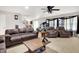 Spacious living room with two leather sofas, two armchairs, ceiling fan, and fireplace at 5063 Haywood Ln, Plainfield, IN 46168