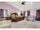 Large main bedroom with vaulted ceilings, carpeting, ceiling fan, and an en-suite bathroom at 5063 Haywood Ln, Plainfield, IN 46168