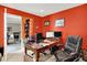 Home office with desk, dual monitors, red walls and door to next room at 5063 Haywood Ln, Plainfield, IN 46168
