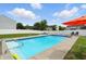 In-ground pool surrounded by pristine landscaping and a secure privacy fence at 5063 Haywood Ln, Plainfield, IN 46168