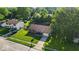 Charming aerial view of a well-maintained home with lush green lawn, mature trees and inviting curb appeal at 5201 Gringo Dr, Indianapolis, IN 46237