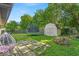 Backyard featuring a trampoline, shed, and a small patio at 5201 Gringo Dr, Indianapolis, IN 46237