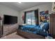 Bedroom with a modern TV and wooden dresser at 5201 Gringo Dr, Indianapolis, IN 46237