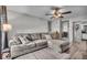 Comfortable living room with a plush sectional sofa and modern ceiling fan at 5201 Gringo Dr, Indianapolis, IN 46237
