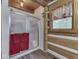 Bathroom with glass enclosed shower, wood paneling and coordinating red and green curtains at 5240 W 400 N, Fairland, IN 46126