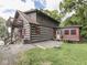 Log cabin exterior featuring a rustic design with a deck and a well-maintained yard at 5240 W 400 N, Fairland, IN 46126